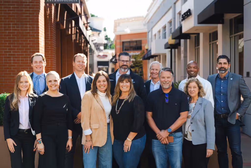Group of Cal Poly Partners board members standing together outdoors in downtown San Luis Obispo, smiling for a professional group photo.