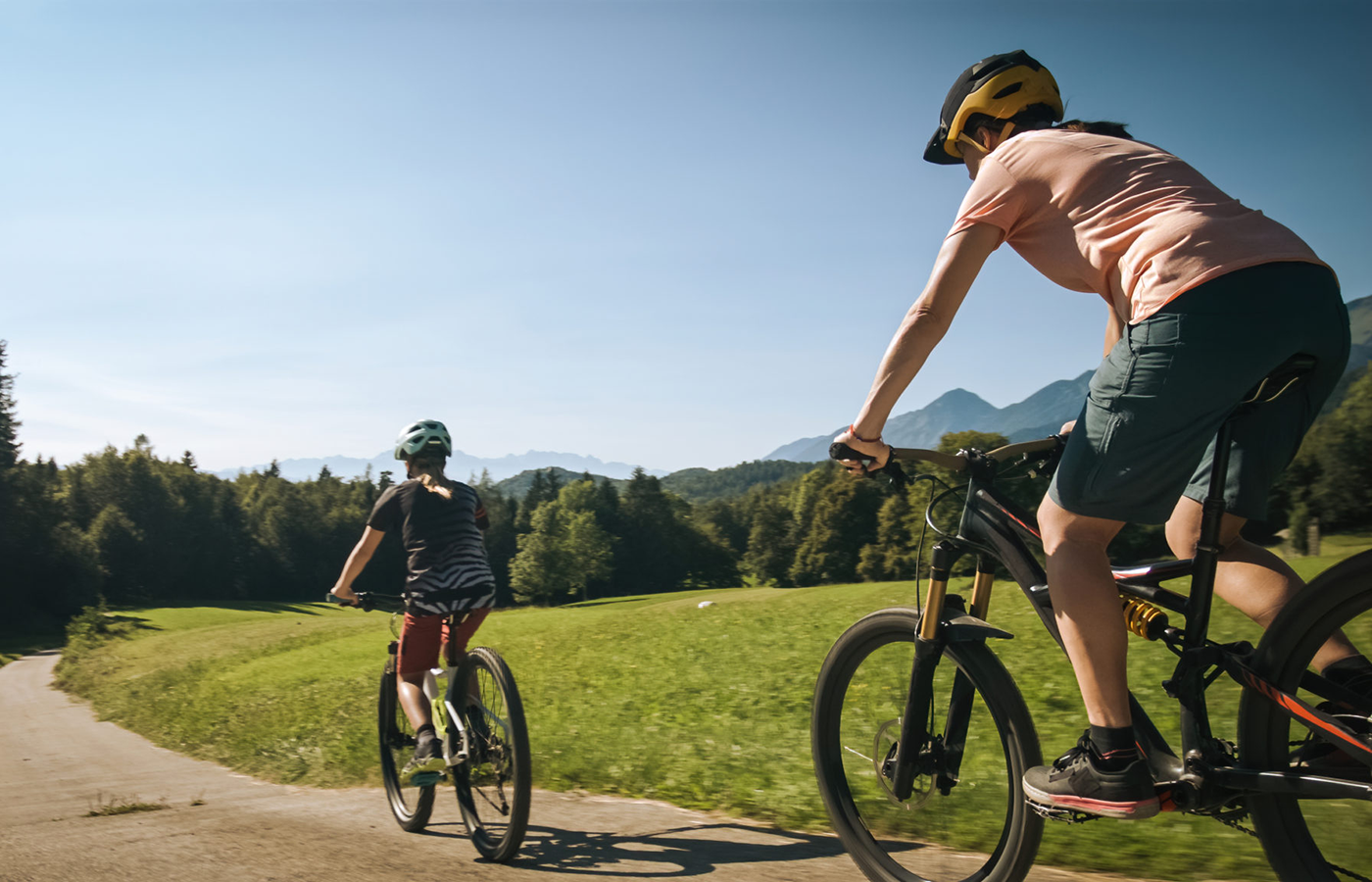 Two people riding bikes